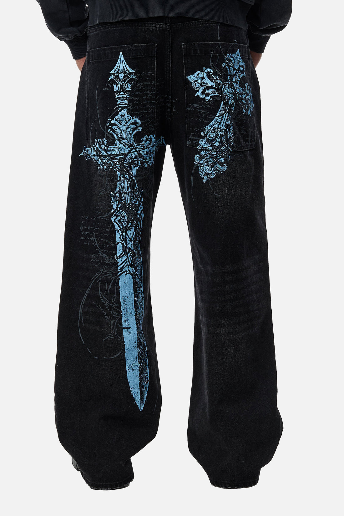 Back view of the black Blade Denim with the light blue sword and cross print on the legs