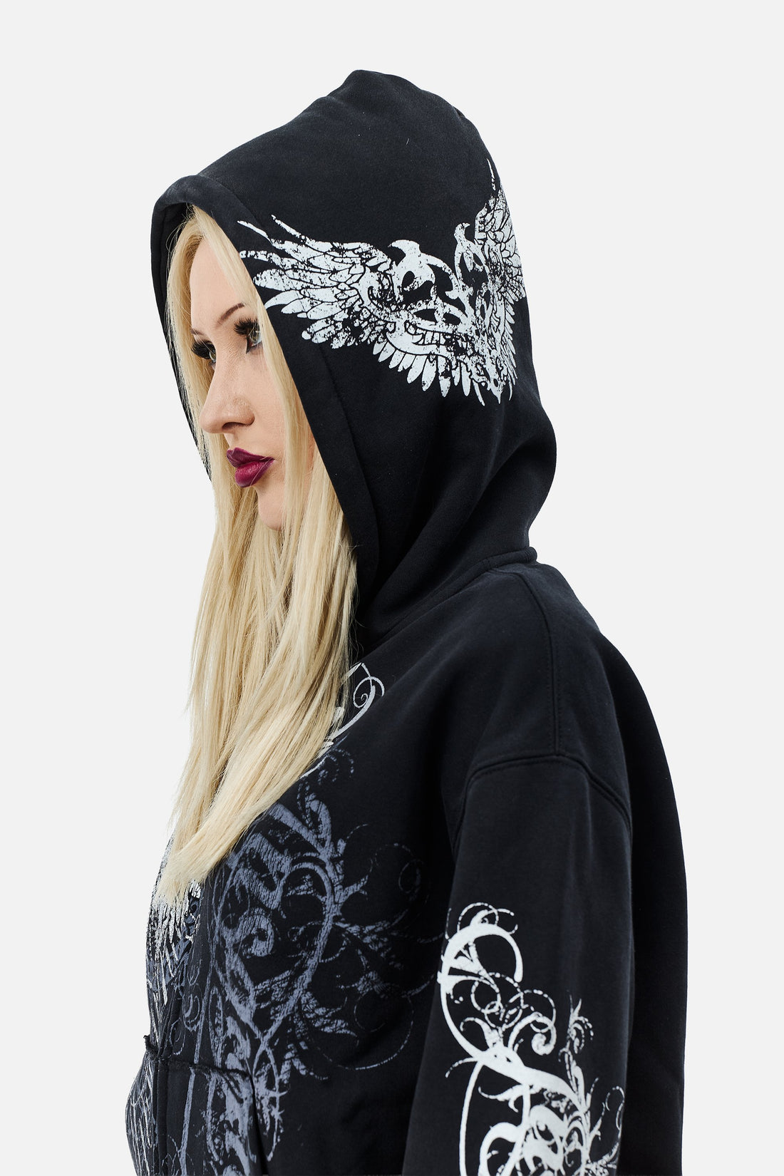 Hood up on the Eternal Zip Hoodie, showing the winged emblem printed on the hood
