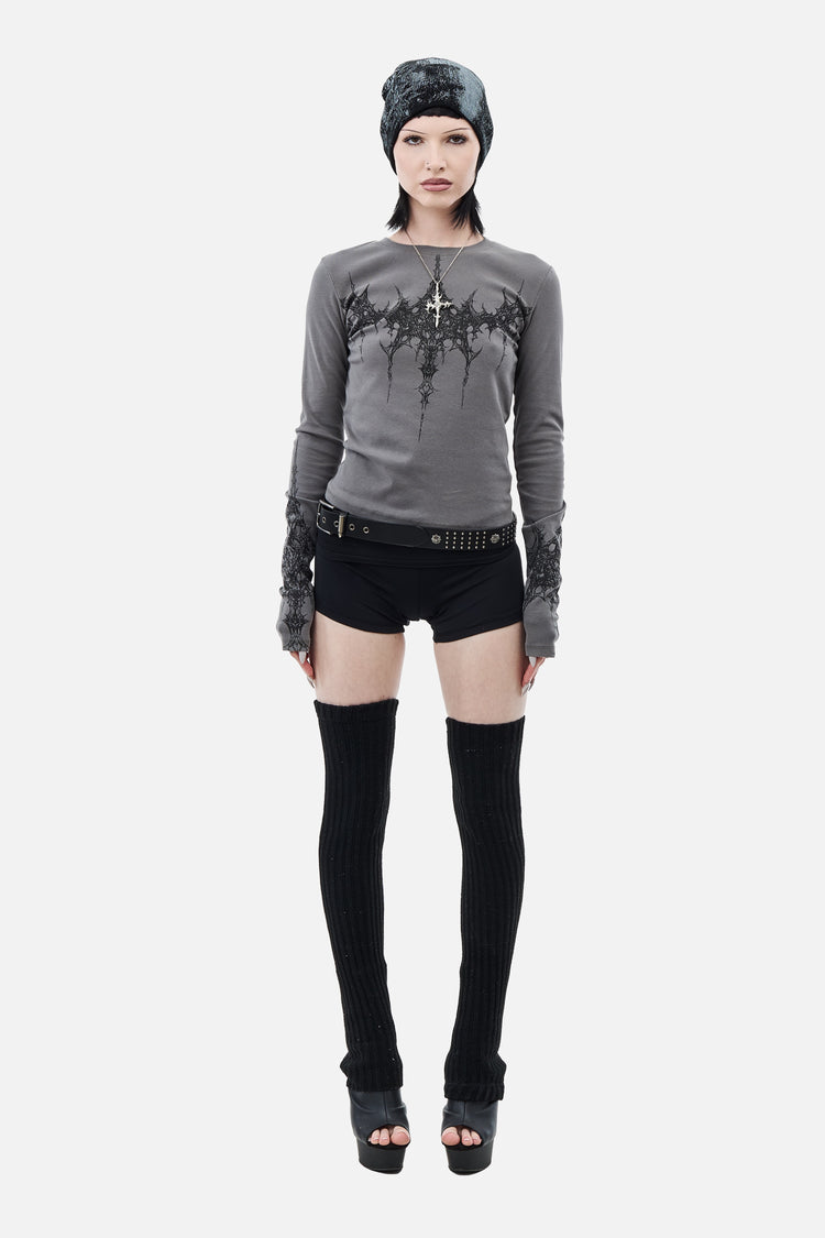 Full-length view of the Tribal Longsleeve styled with black shorts and thigh-high socks