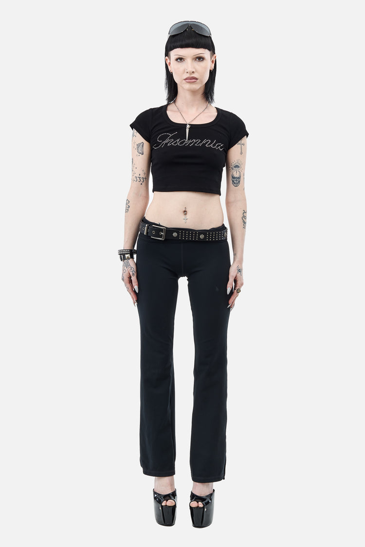 Full-length view of the Rhinestone Cursive Tee styled with black flares and platform heels