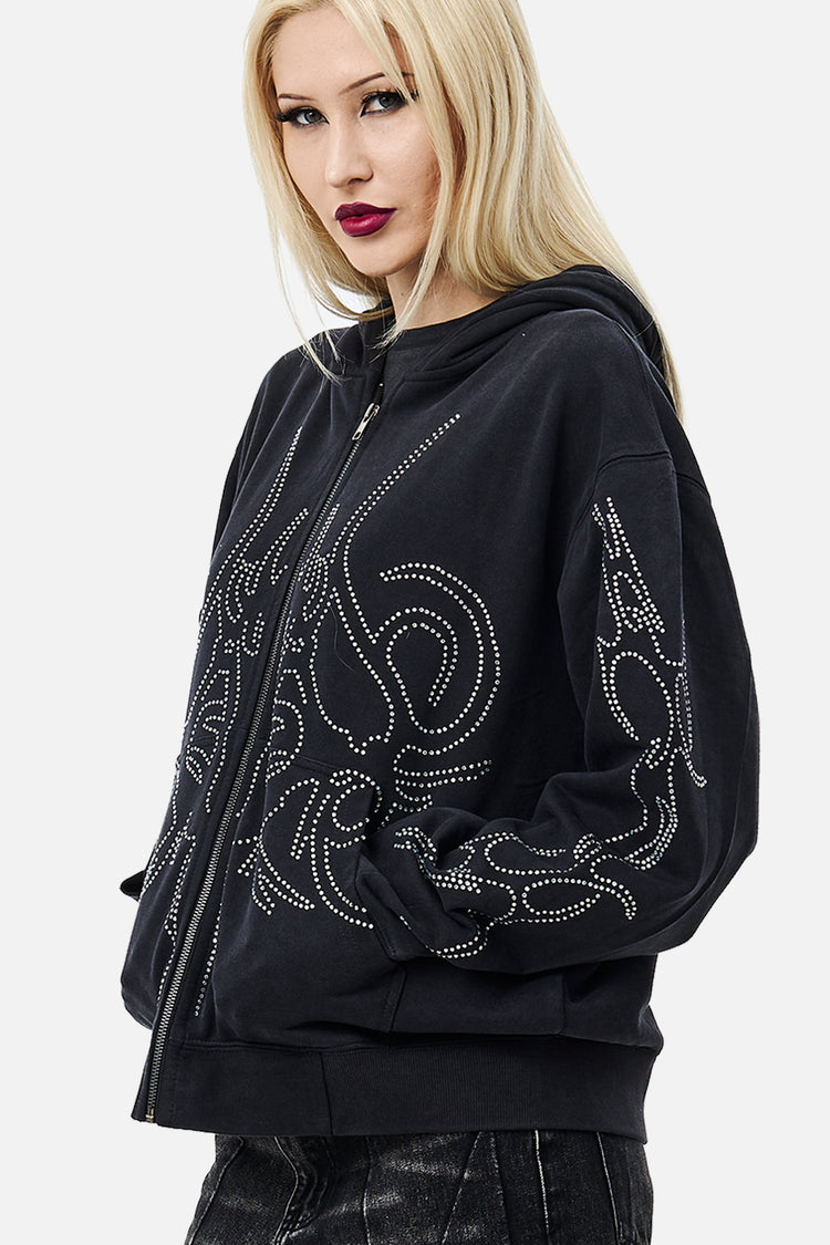 Three-quarter close-up of the rhinestone sigil detailing on the black Sigil Rhinestone Zip Hoodie