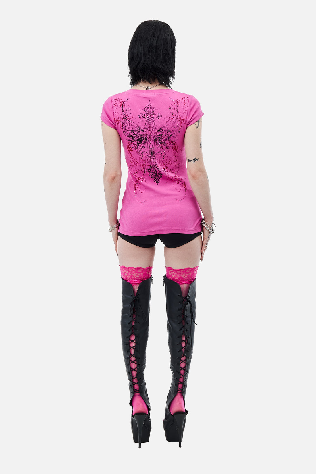 Back view of the pink Lovers V-Neck T-Shirt showing the cross print, with thigh-high boots