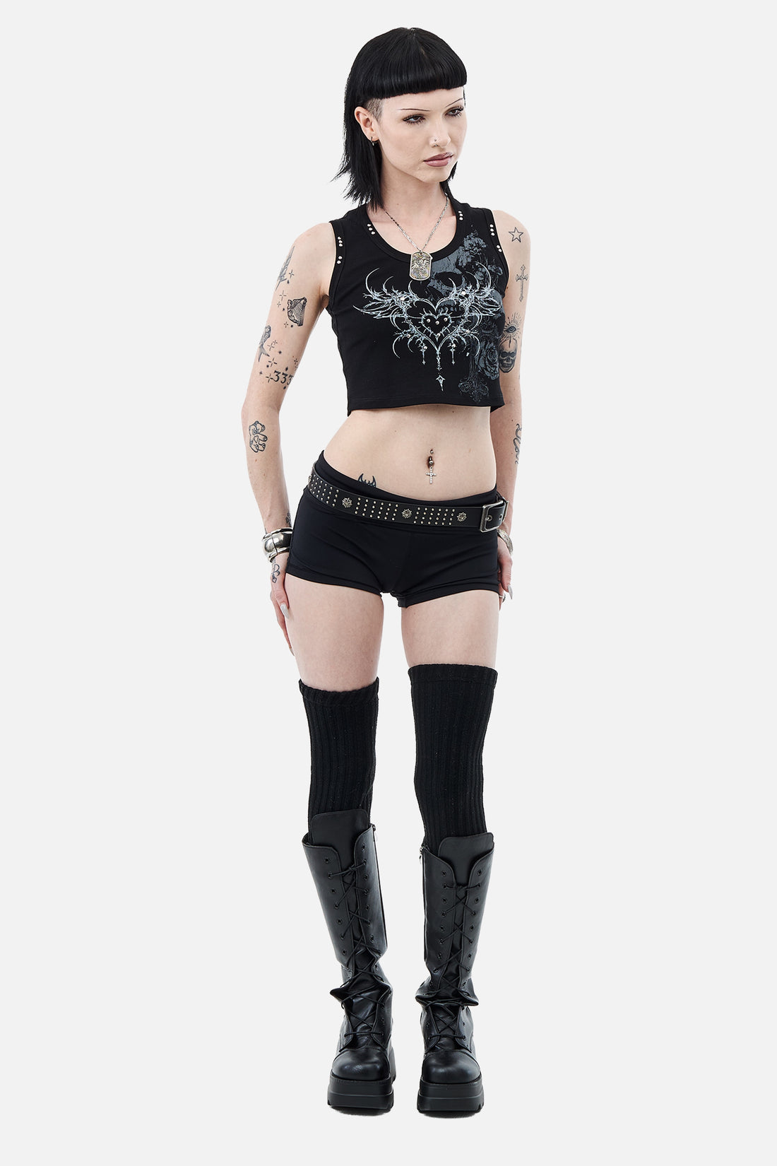 Model in the Black Sigil Tank with black shorts and knee-high boots, full-length view