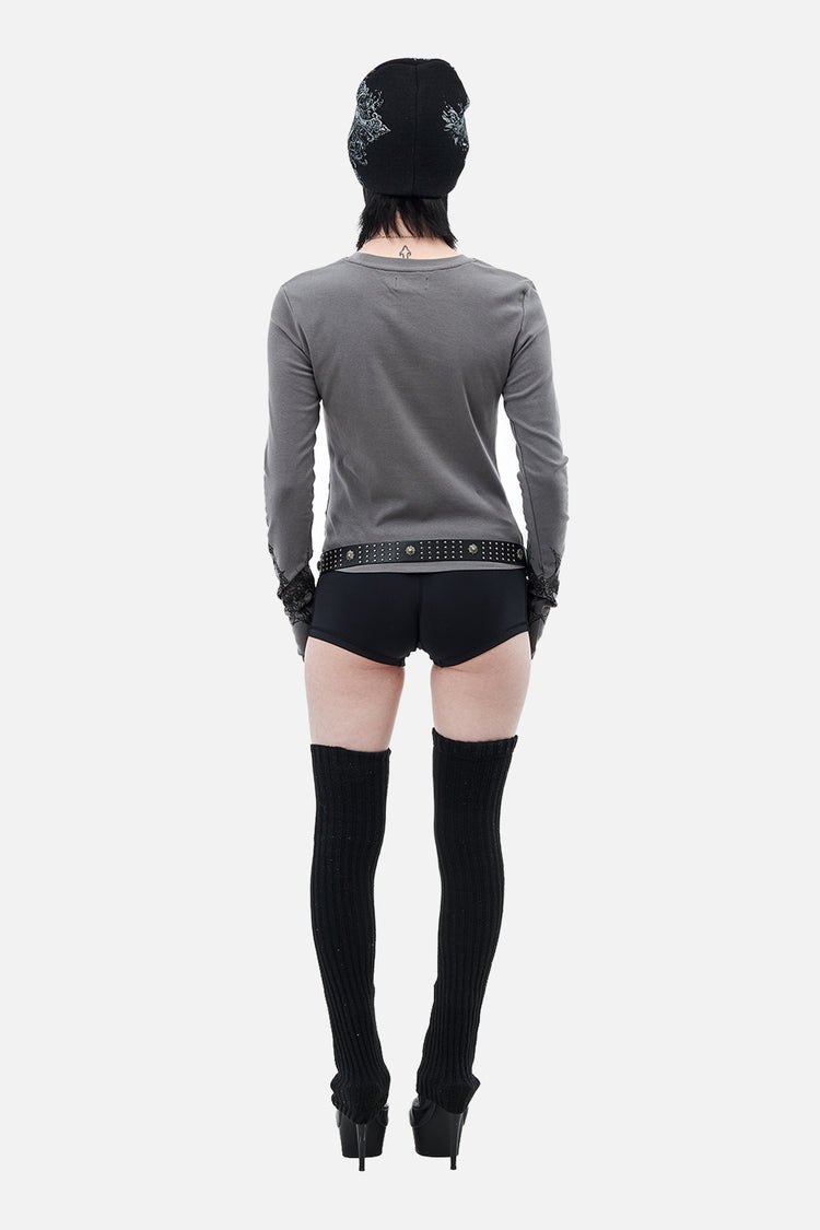 Back view of the gray Tribal Longsleeve with black shorts and thigh-high socks