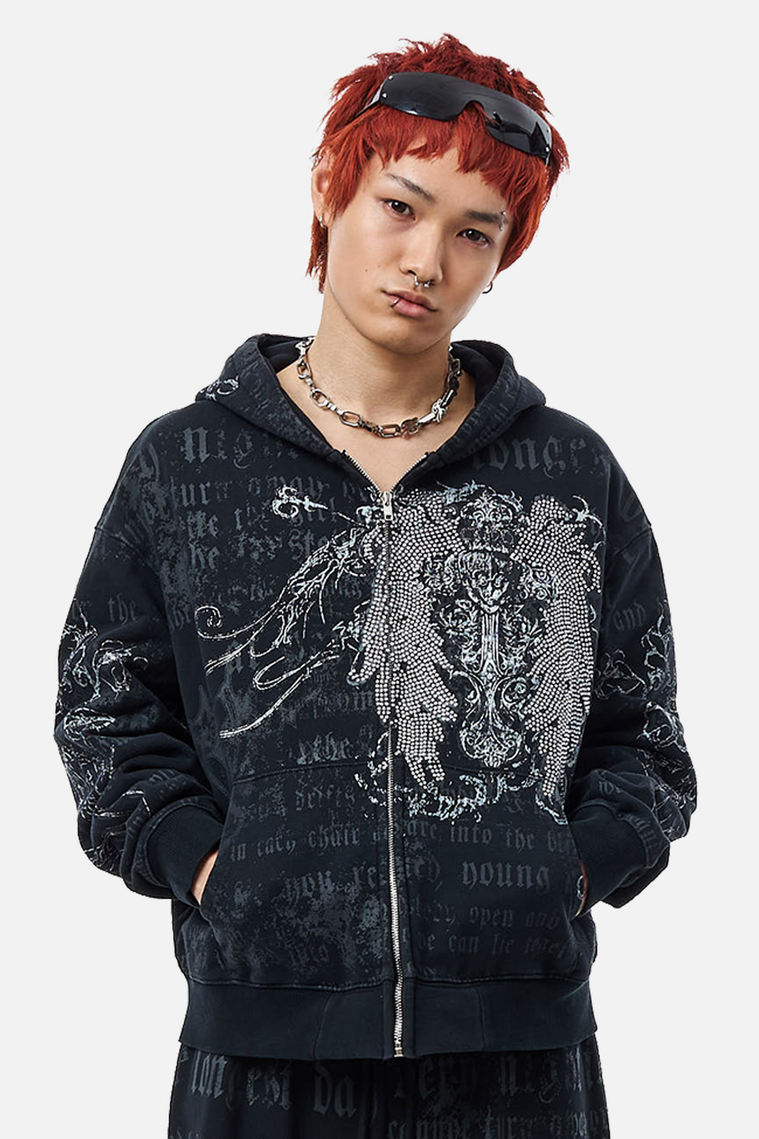 Model wearing the Sacred Zip Hoodie with rhinestone winged cross and gothic script all-over print