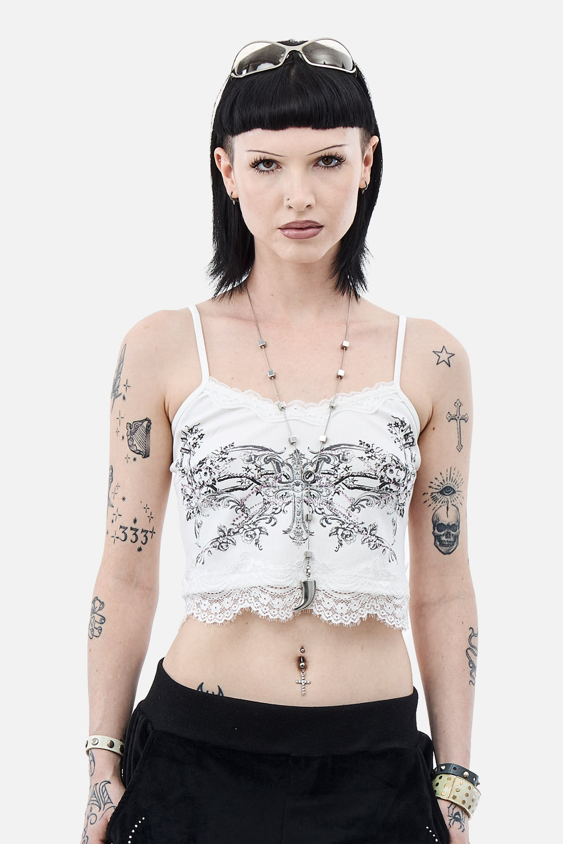 Model wearing the white Blessed Cami Top with grey floral print and lace hem, front view