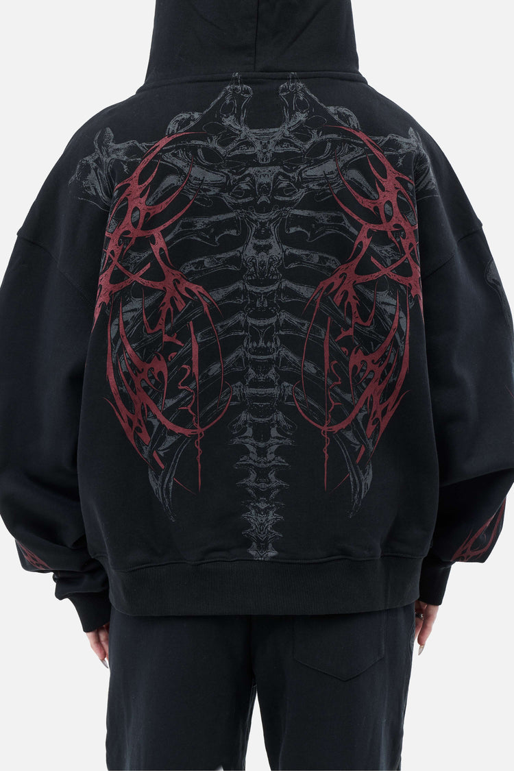 Close-up back view of the Skeleton Hoodie's grey spine graphic with red thorn wings