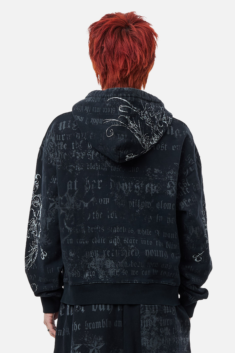 Back view of the Sacred Zip Hoodie showing the faded gothic script print and hood embroidery