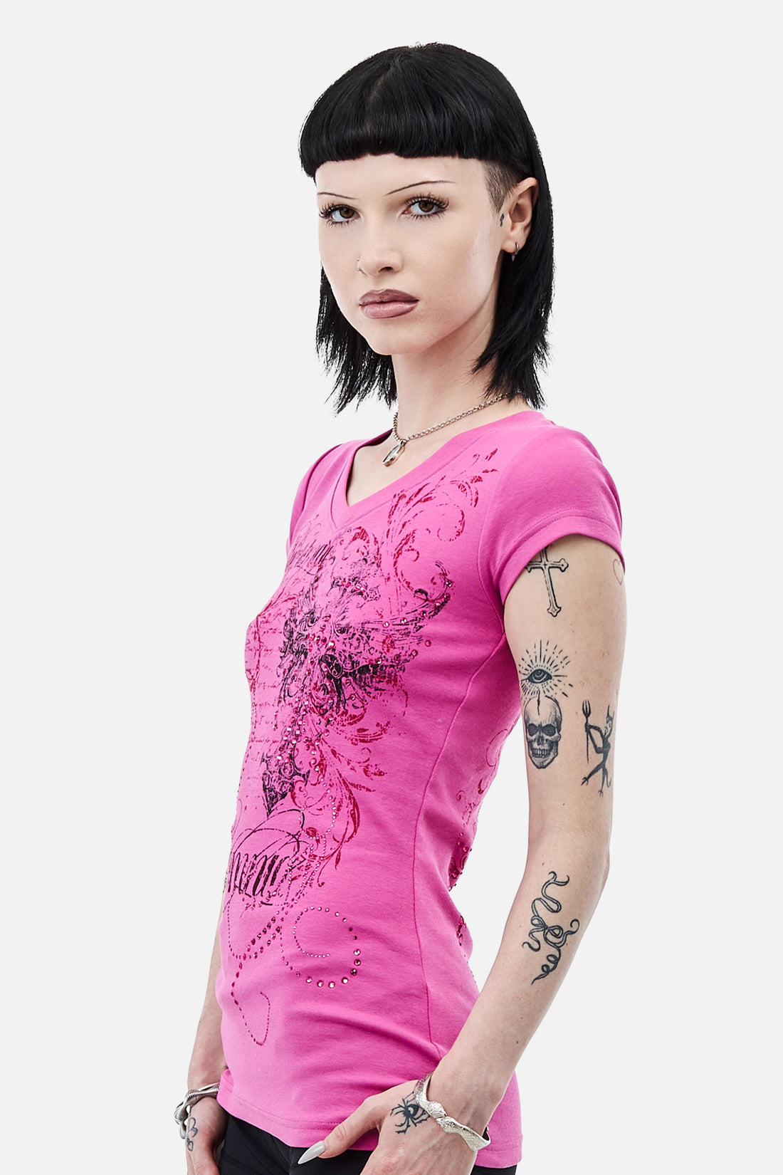 Three-quarter view of the Lovers V-Neck T-Shirt showing the side print and tattooed arm