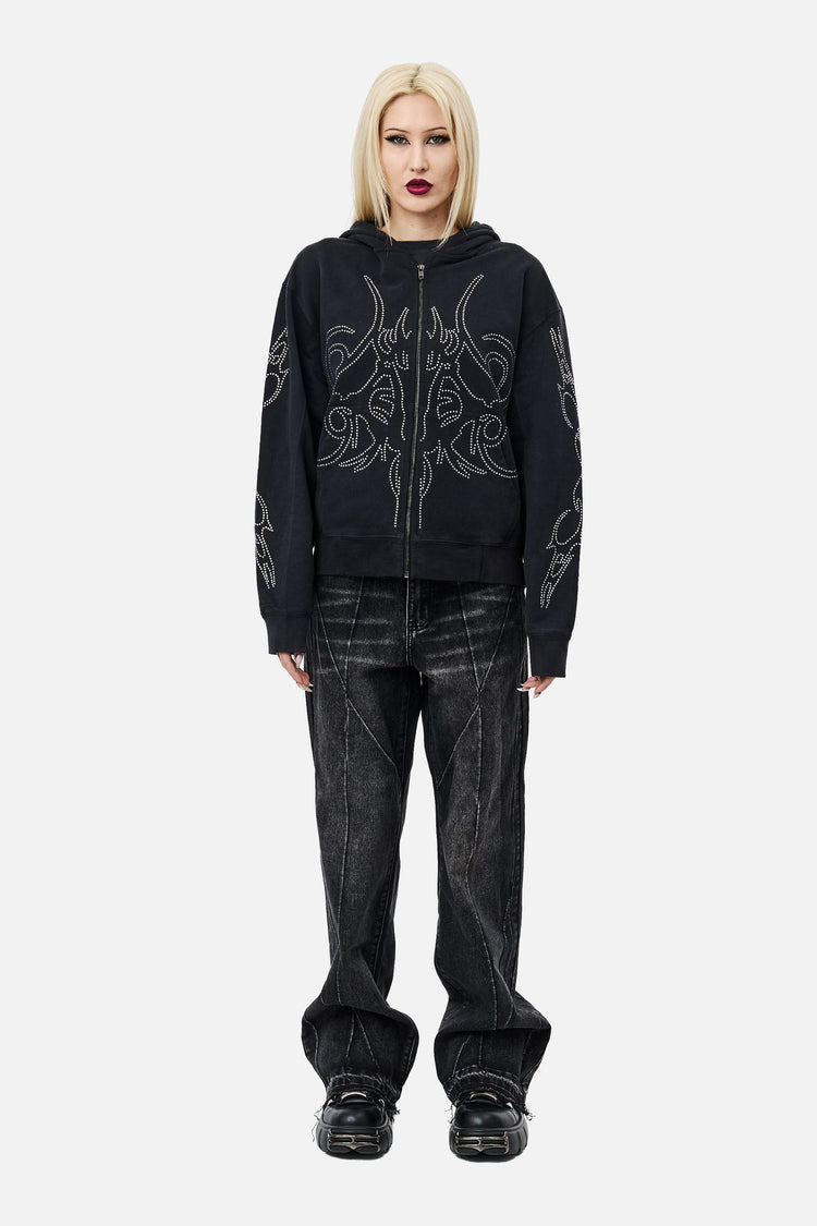 Model in the Sigil Rhinestone Zip Hoodie with black washed jeans, full-length front view