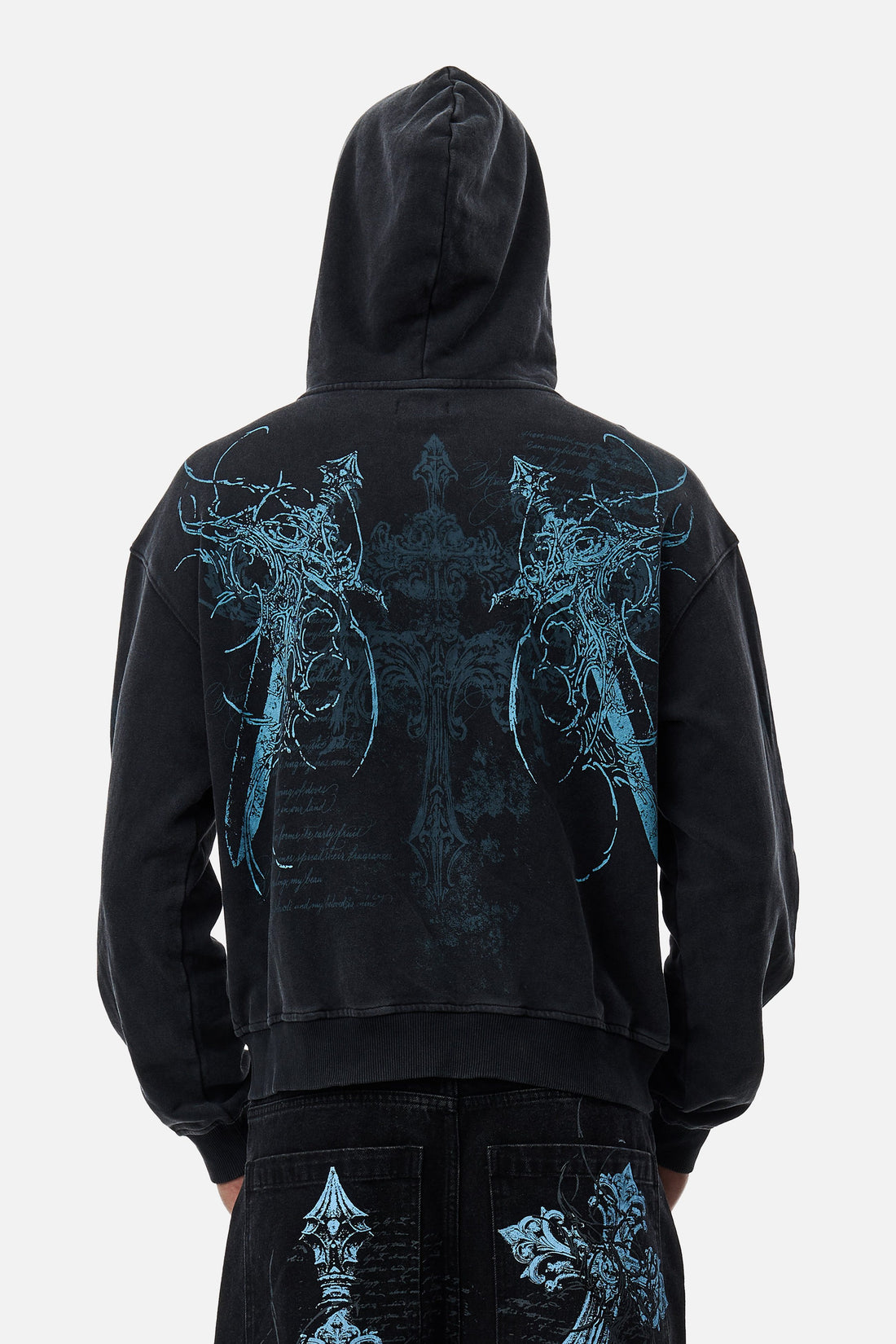 Back view of the Blade Hoodie with hood up, showing blue winged cross print