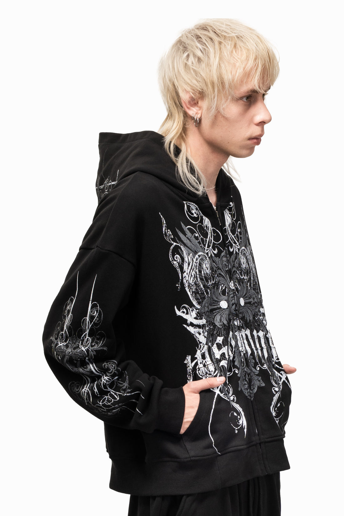 Side profile of the black Crux Hoodie showing the sleeve graphic and hood