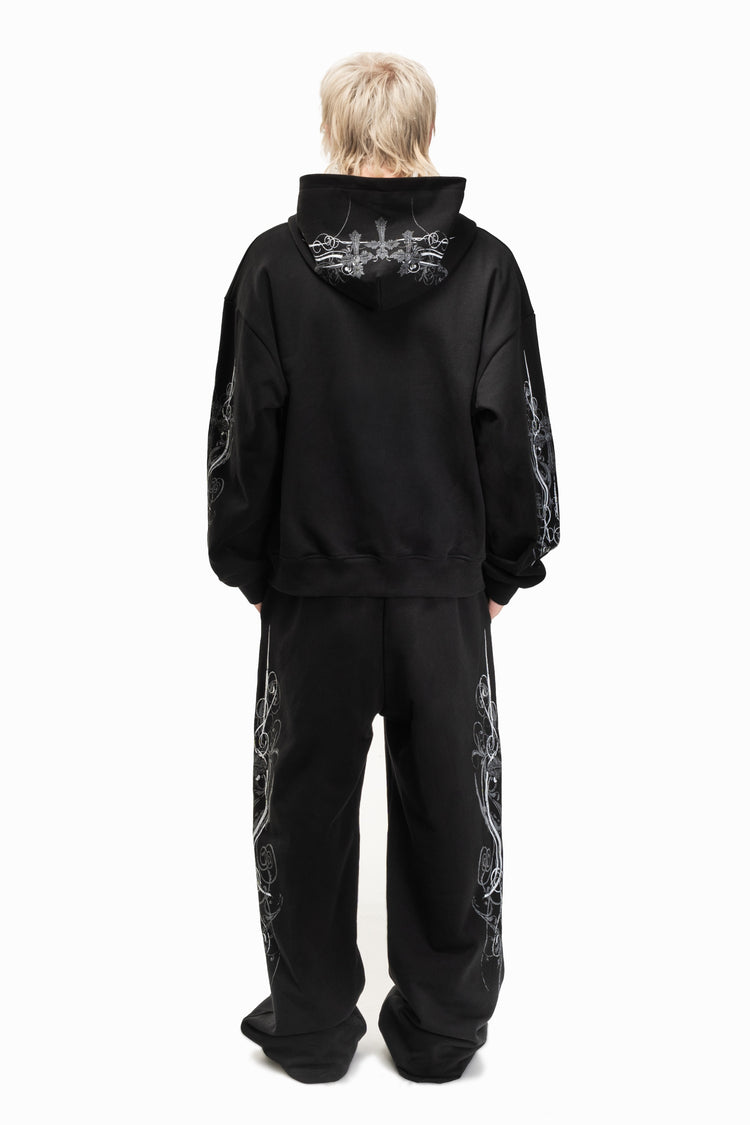 Back view of the black Crux Hoodie with matching sweatpants, full length