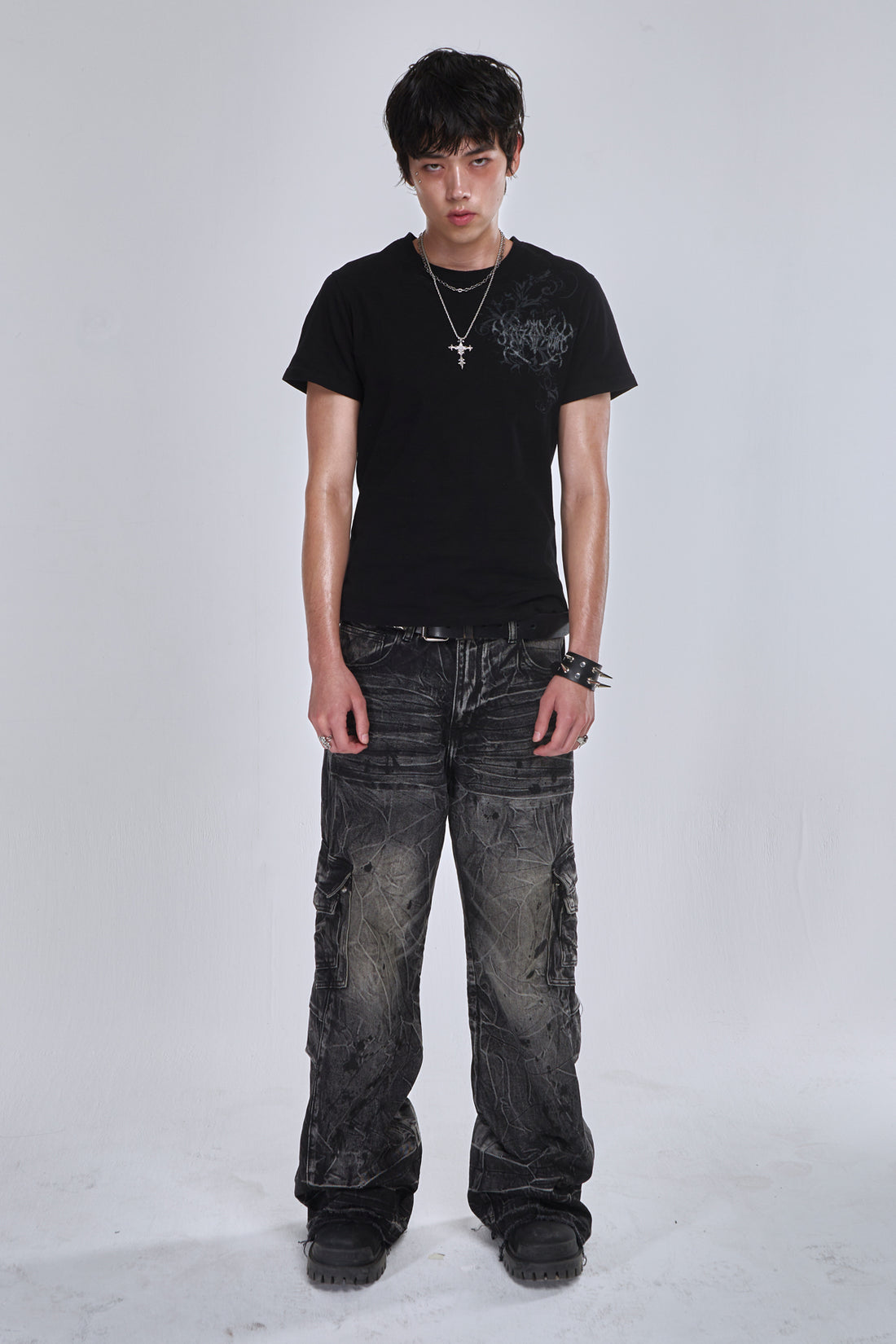 Model wearing the washed black Fractured Denim cargo jeans with a black tee, full-length view