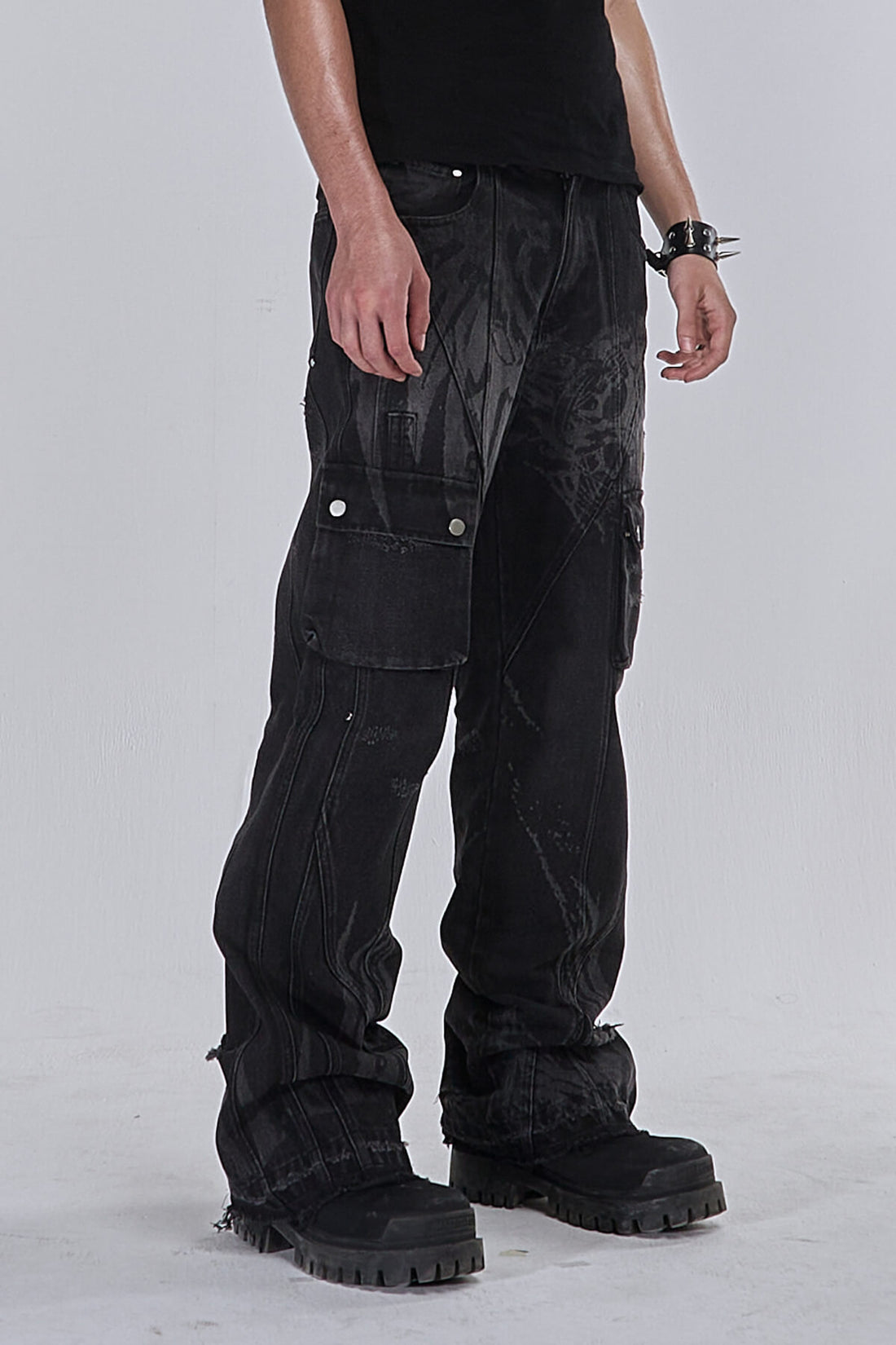Side view of the Destroyer Denim with cargo pockets, faded wash and black boots