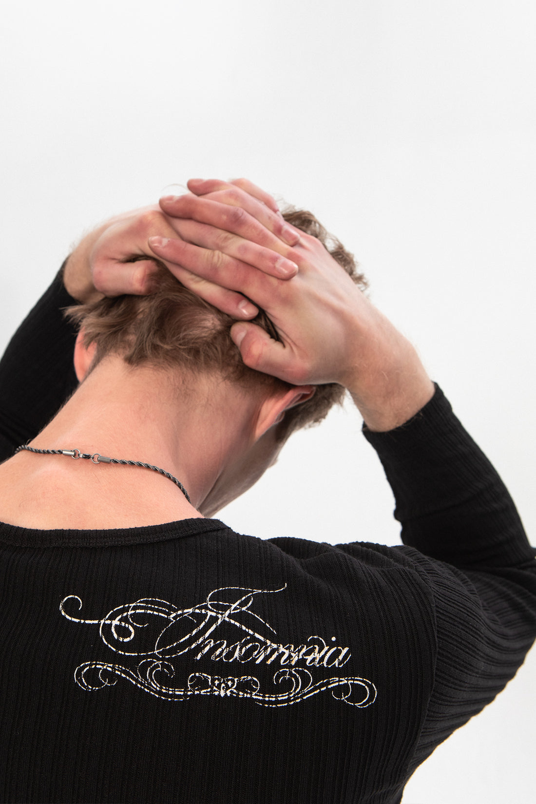 Close-up of the Insomnia script embroidery on the back of the Moon Ribbed Long Sleeve