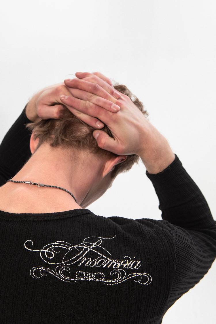 Close-up of the Insomnia script embroidery on the back of the Moon Ribbed Long Sleeve