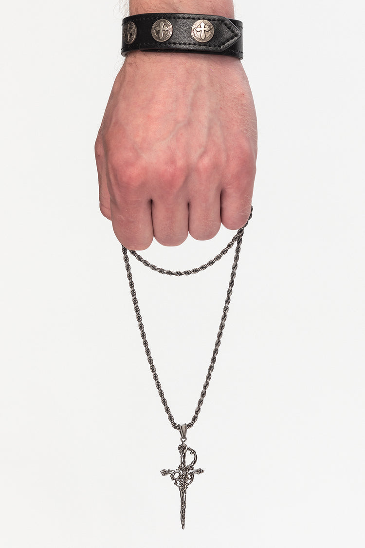 Silver Dagger Necklace hanging from a hand on a rope chain, with ornate dagger pendant