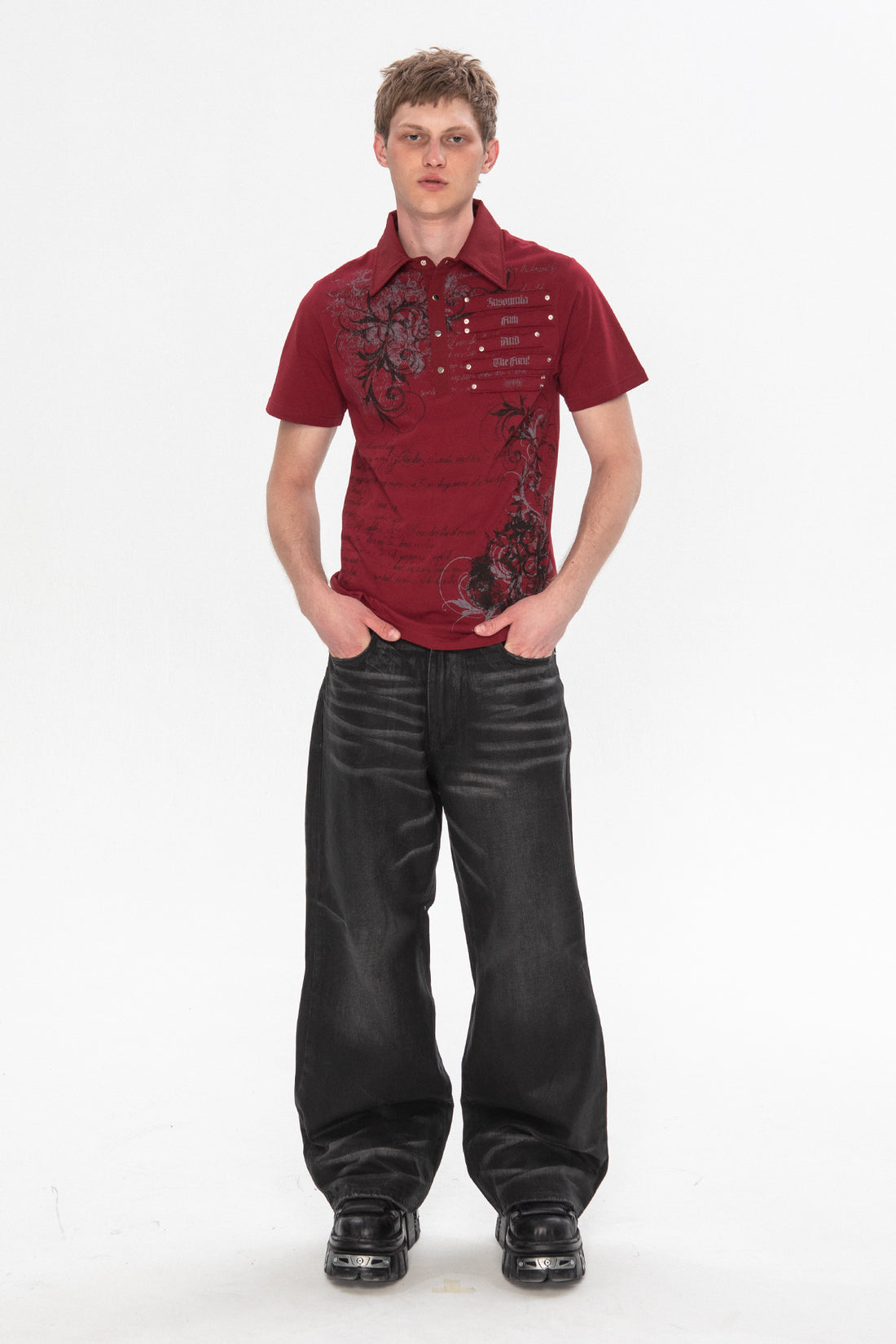 Full-length view of the red Thorns Polo with coated black baggy jeans