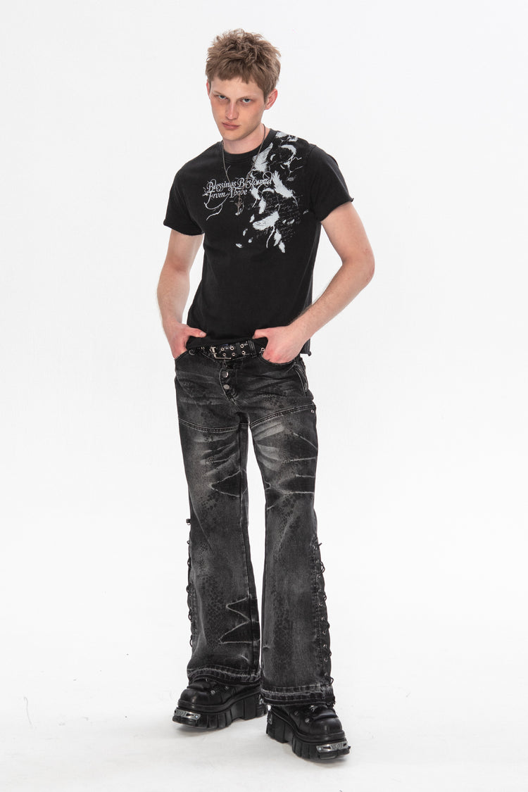Model wearing the Snakeskin Flared Denim with a black graphic tee and chunky boots, full length