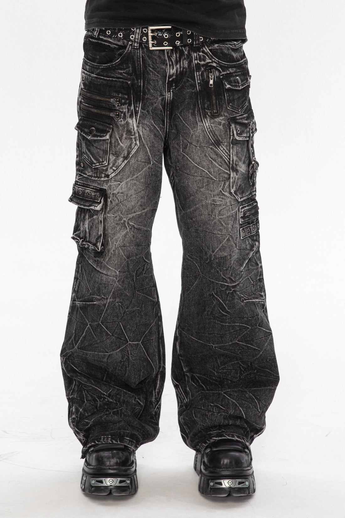 Front view of the Utility Denim, washed black cargo jeans with crinkle wash and studded belt