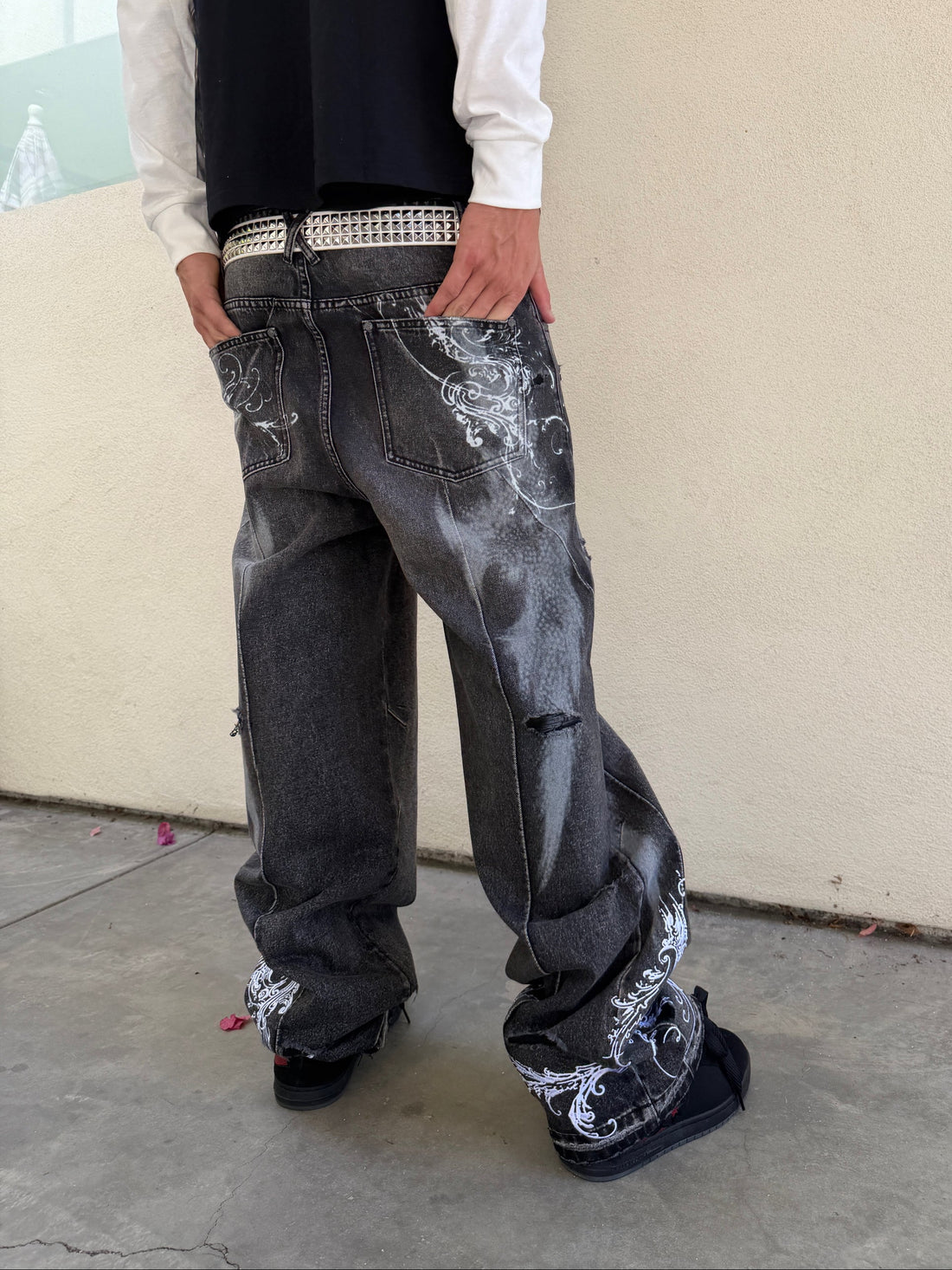 Side view of the baggy grey Fleur Destroyer Denim V2 with printed hems