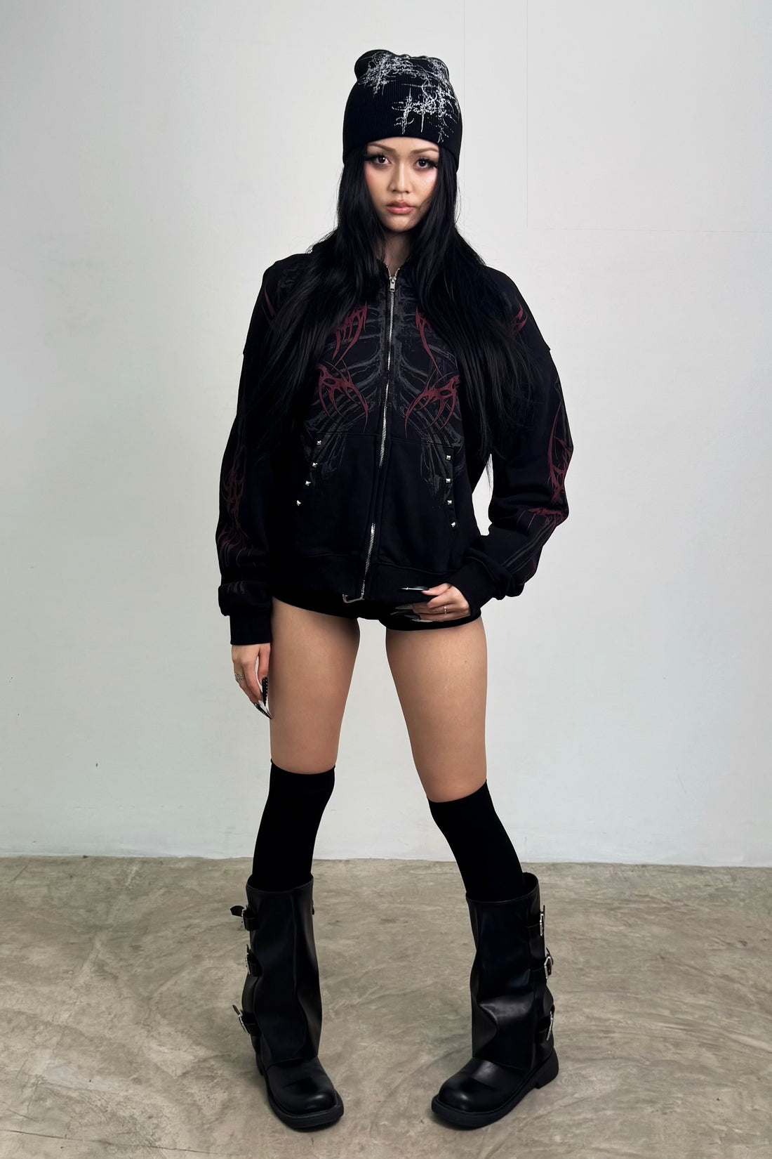 Full-length view of the Skeleton Hoodie styled with black knee socks and boots
