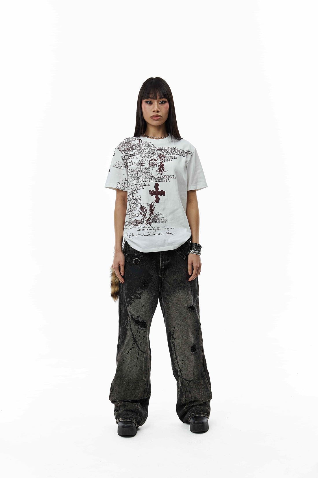 Model in the White Messages Tee and distressed black jeans, full-length front view