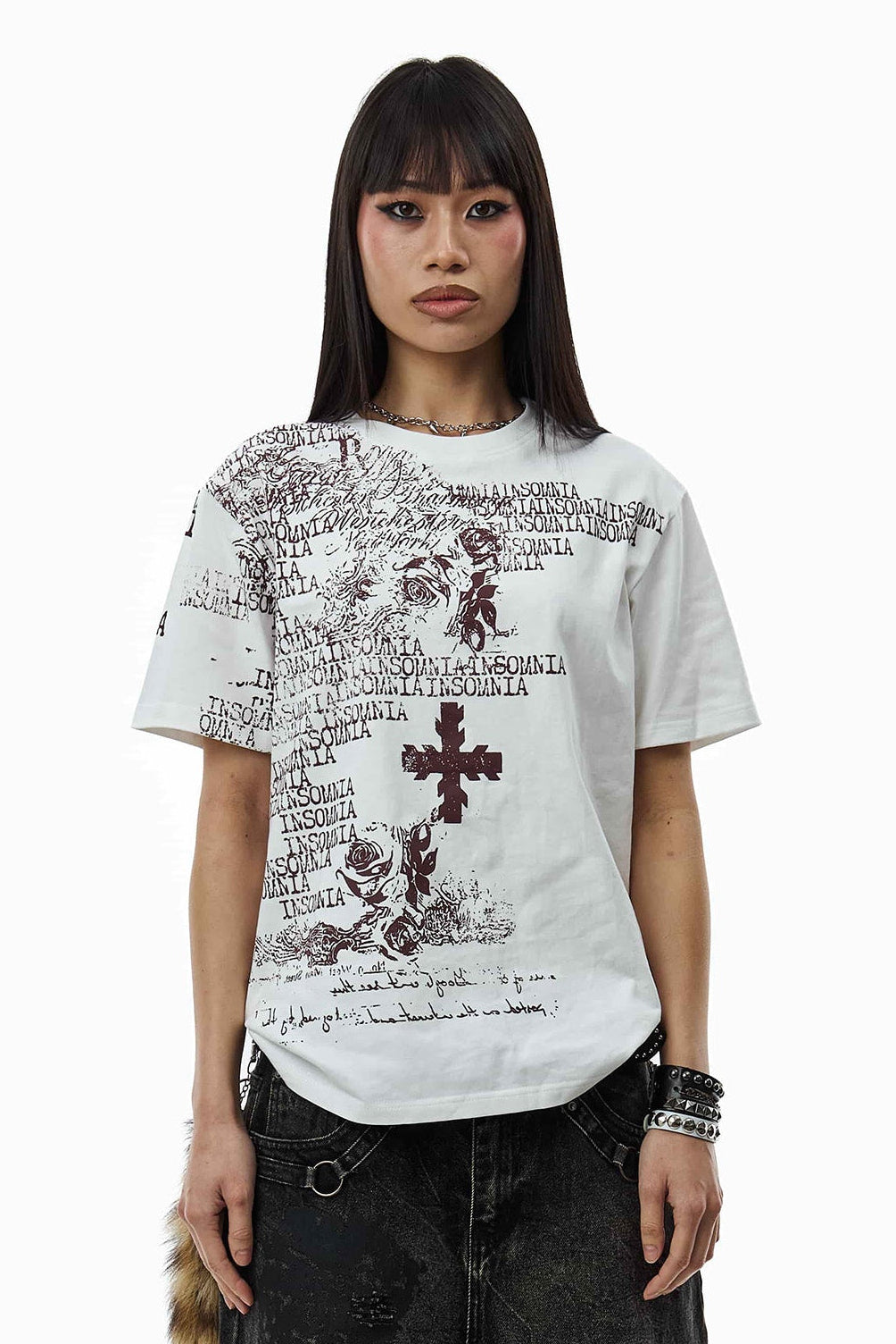 Model wearing the White Messages Tee with burgundy Insomnia text and cross, waist-up