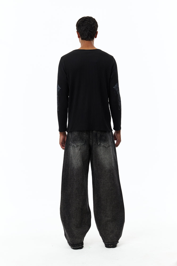 Full-length back view of the plain black Scripture Ribbed Long Sleeve with baggy jeans