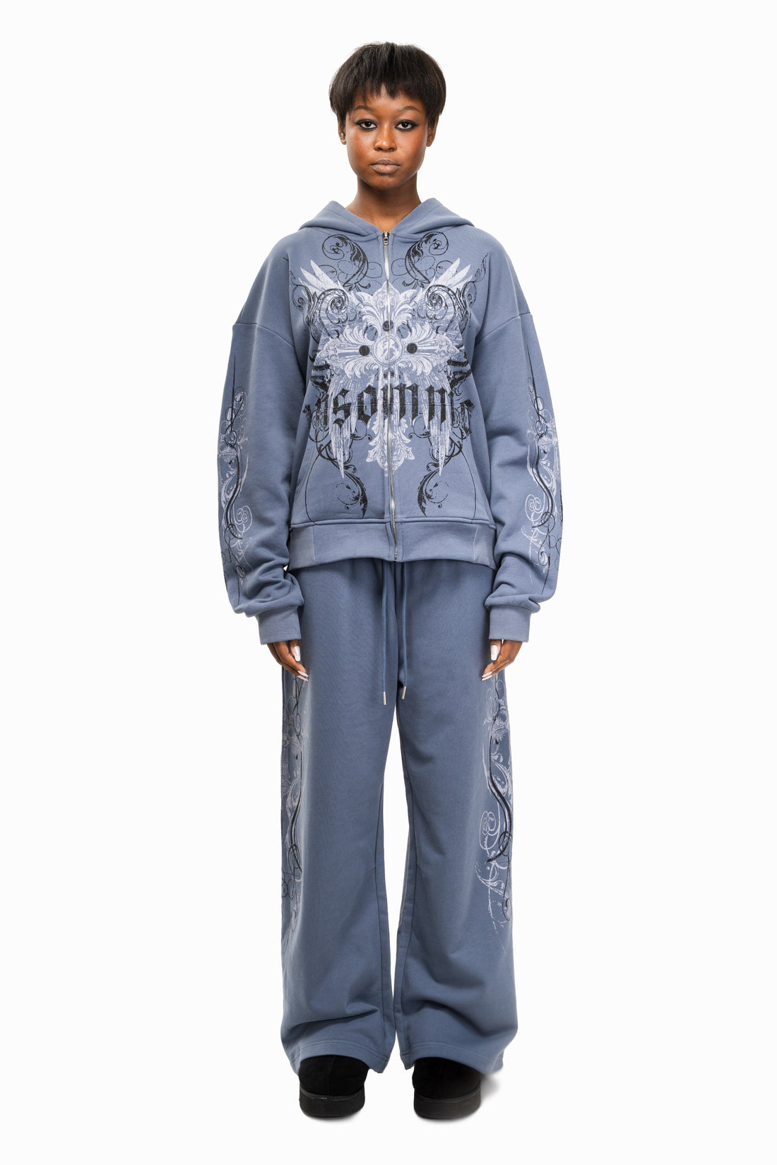Model wearing the Midnight Blue Crux Sweatpants with matching zip hoodie, front view