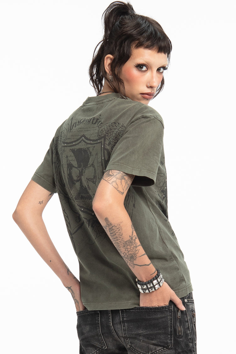 Model looking over her shoulder in the Studded Wings Tee, showing the back crest print