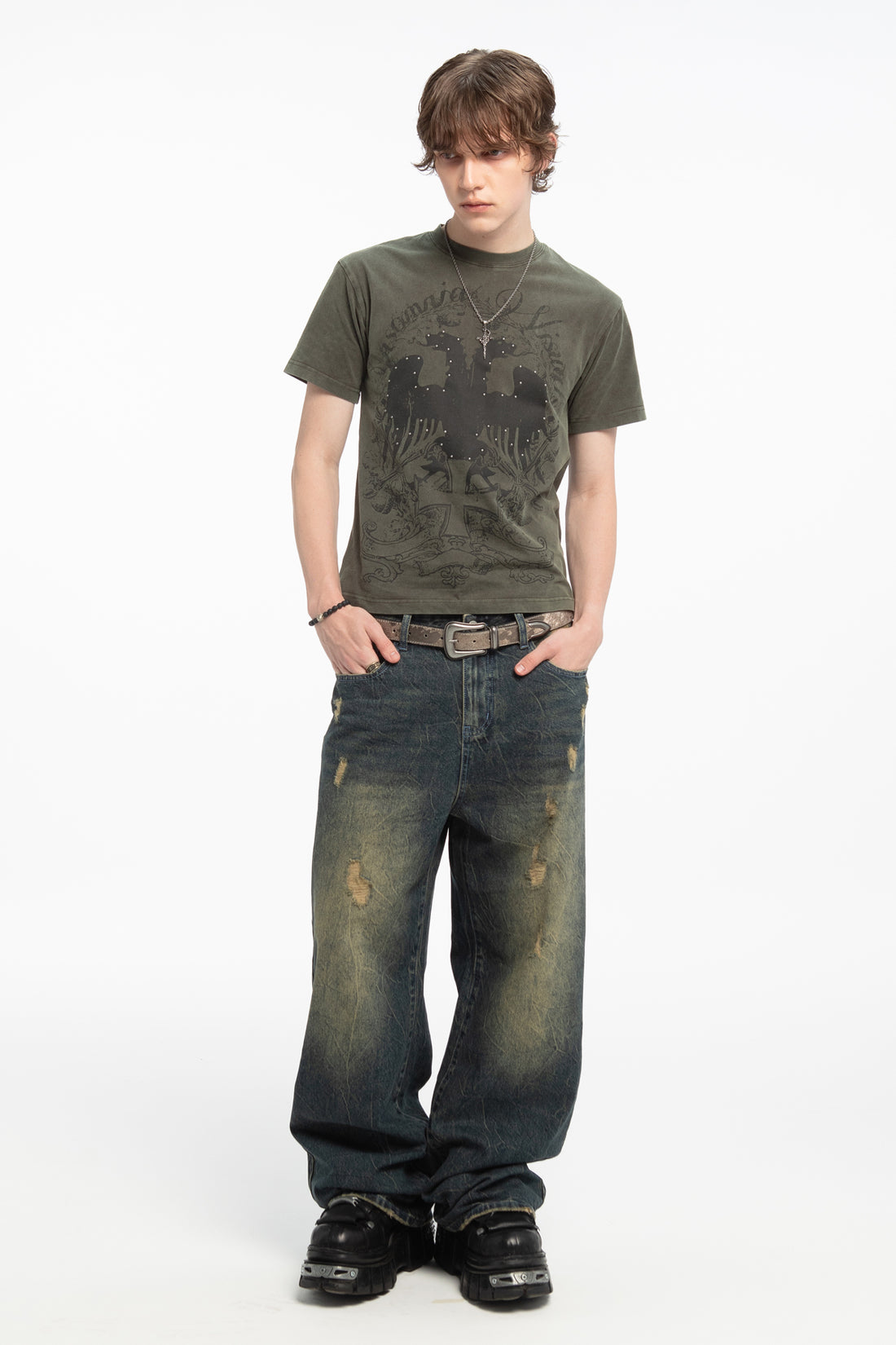 Full-length view of the Studded Wings Tee styled with faded baggy jeans and a western belt