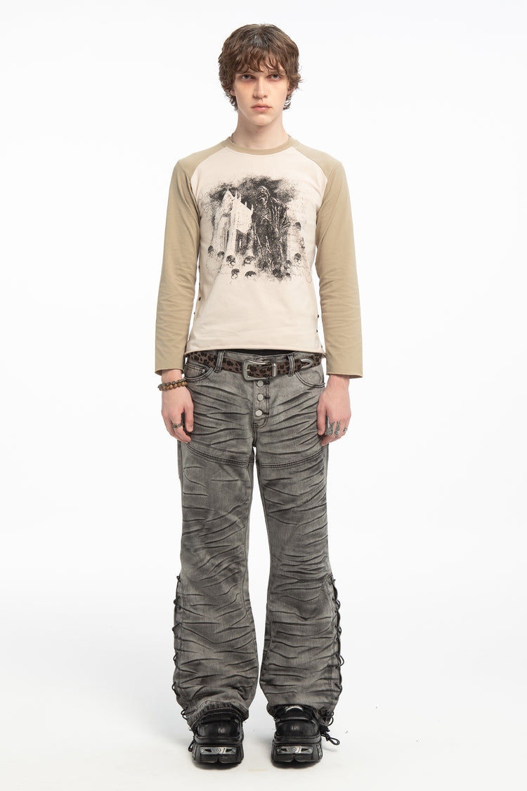 Full-length front view of the Reaper Raglan Long Sleeve with grey wide-leg jeans