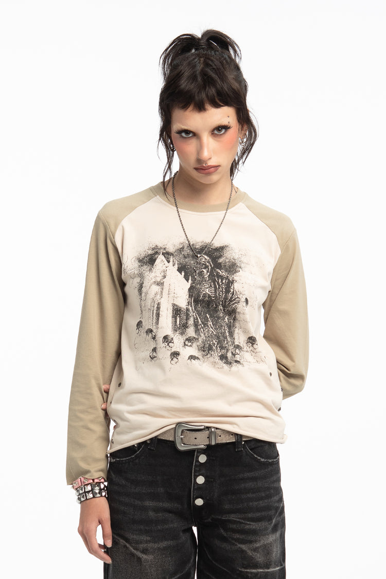 Model wearing the cream and beige Reaper Raglan Long Sleeve with grim reaper photo print