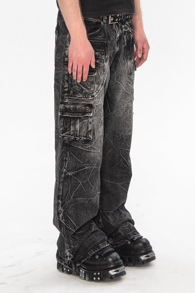 Side view of the Utility Denim stacked over black platform boots, showing the cargo pocket