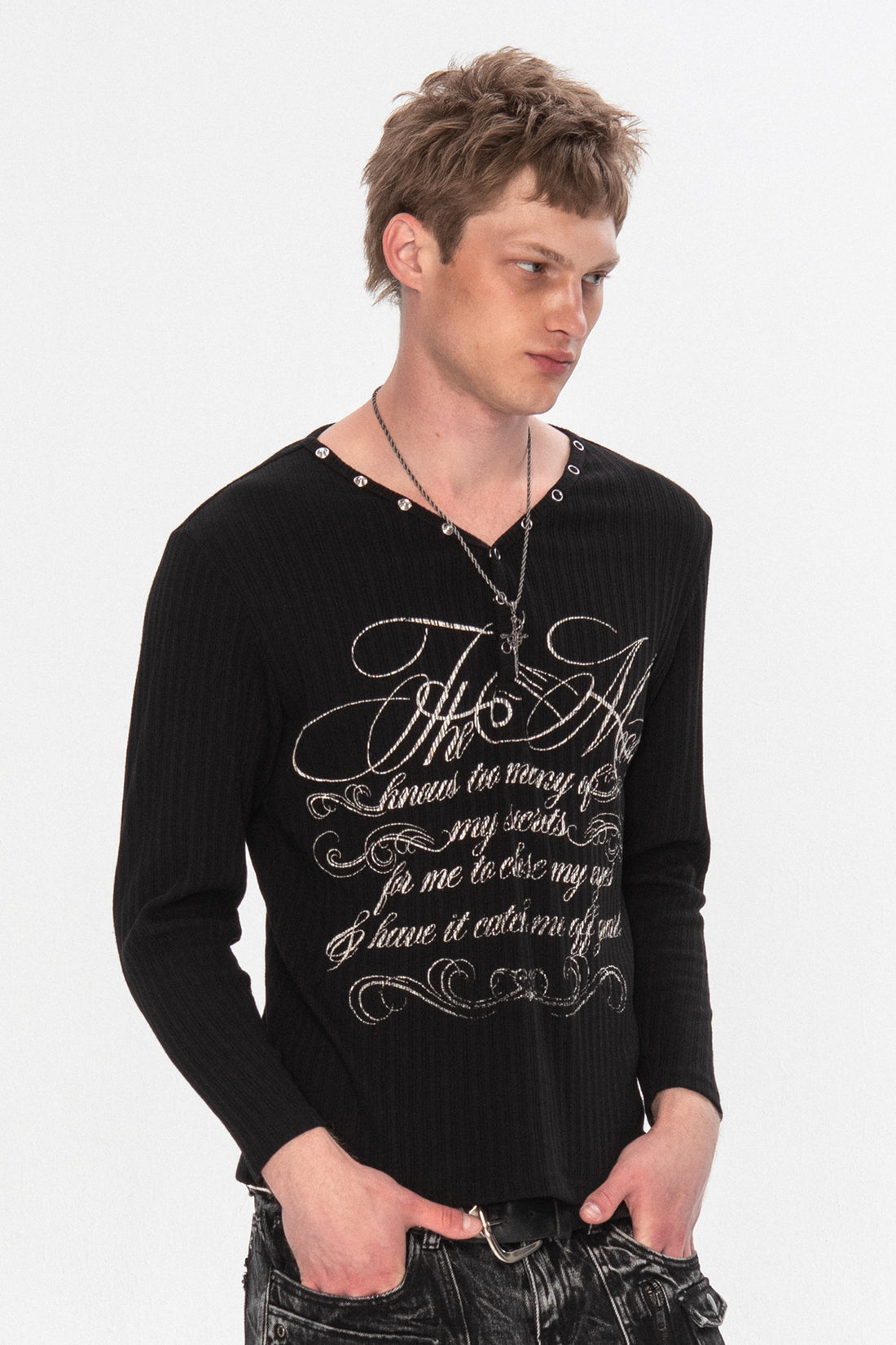 Model wearing the black Moon Ribbed Long Sleeve with silver script print and studded V-neck
