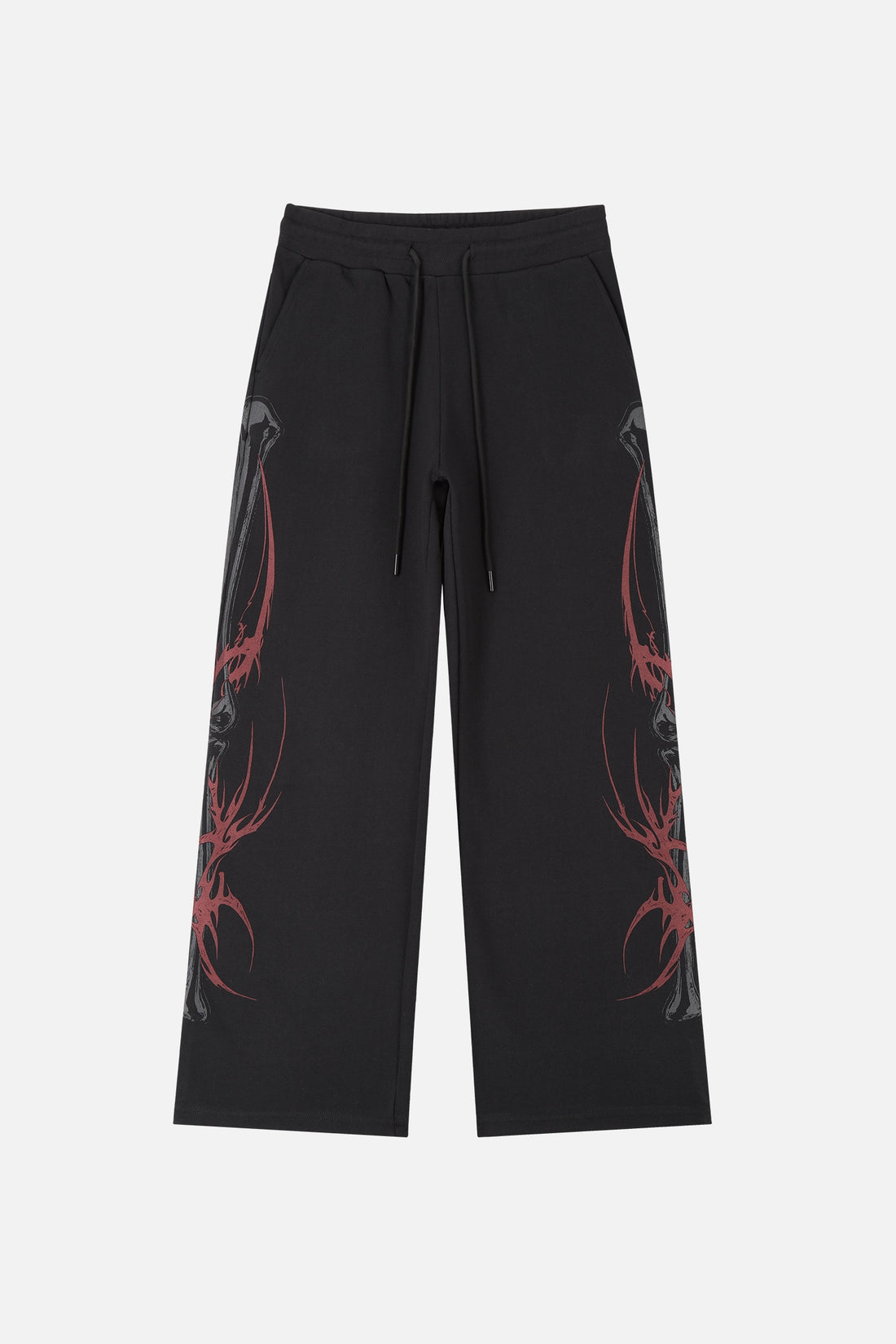 Front of the black Skeleton Sweatpants laid flat with red tribal spine prints on both legs
