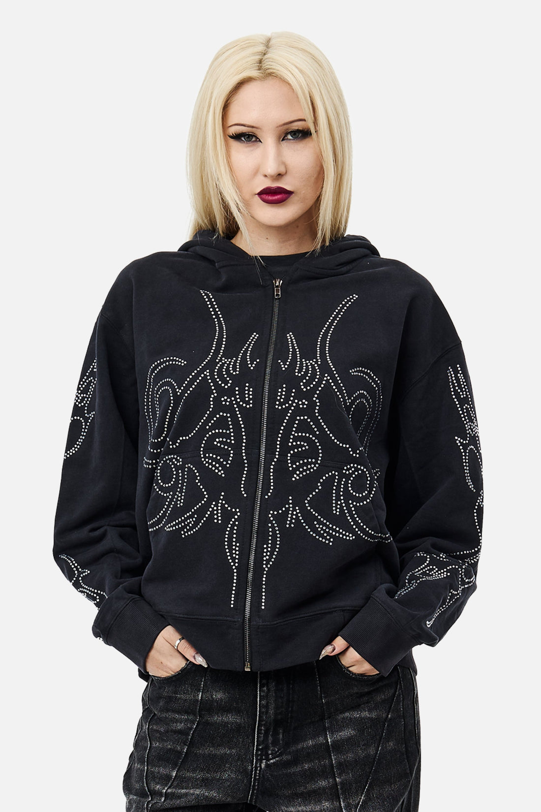 Model wearing the black Sigil Rhinestone Zip Hoodie with rhinestone sigil design, front view