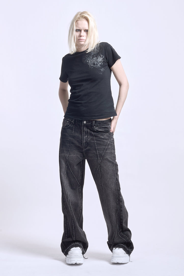 Model in the black Vex Denim with a black tee and white sneakers, full-length front view