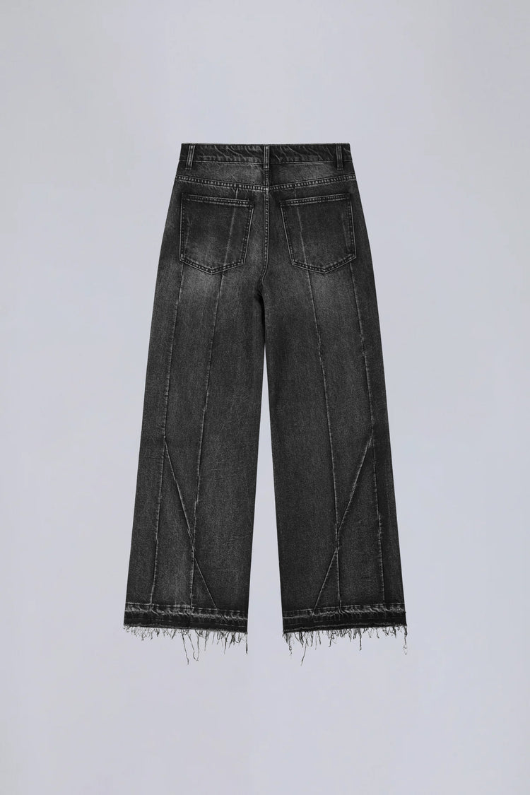 Back of the washed black Vex Denim laid flat with frayed raw hems