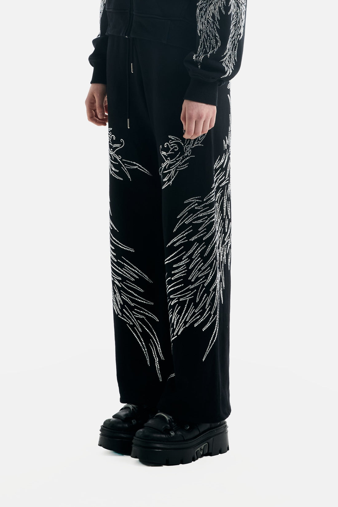 Side view of the All Over Wings Rhinestone Sweatpants showing rhinestone wing design