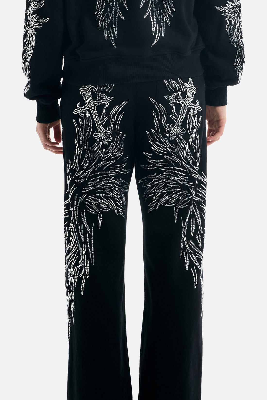 Close back view of the All Over Wings Rhinestone Sweatpants showing rhinestone crosses and wings