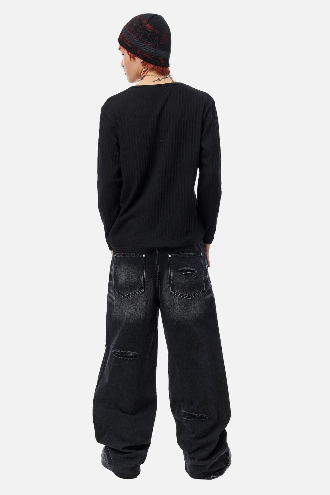 Back view of the plain black Fate Ribbed Long Sleeve with baggy black jeans