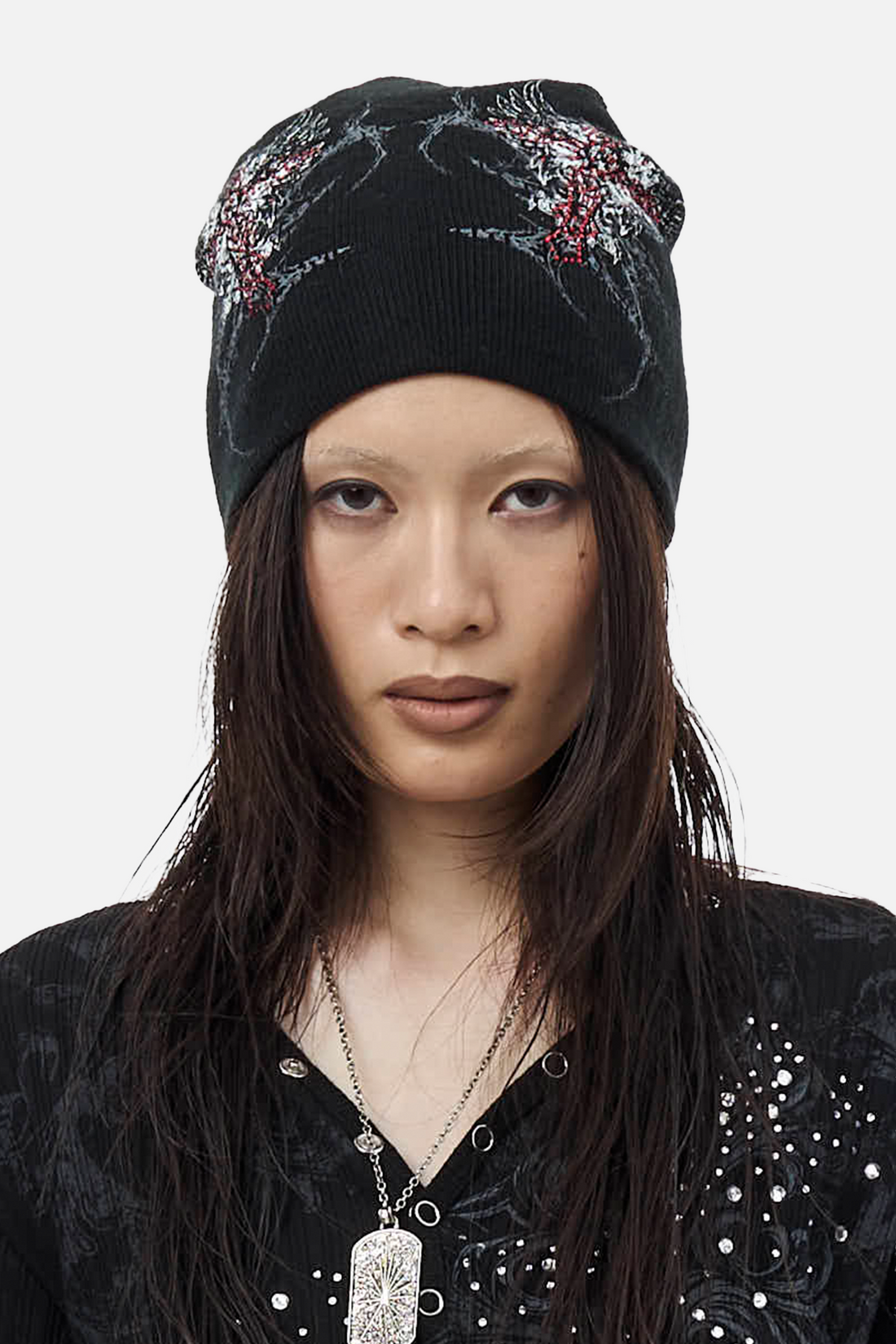 Front view of the black Blessed Beanie worn over long dark hair