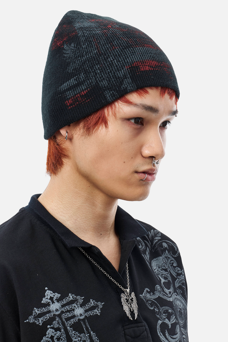 Side view of a model wearing the black and red Chaos Beanie with a printed polo