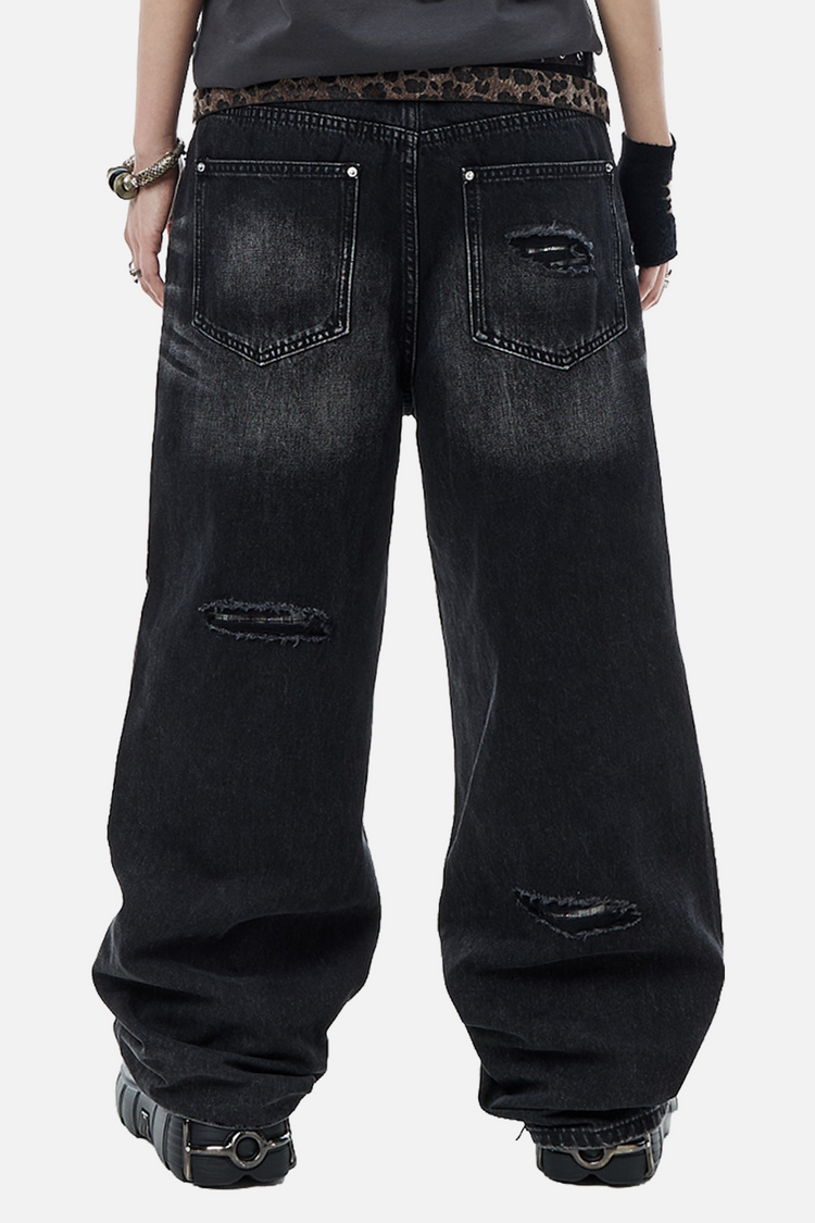 Close back view of the Plaid Patch Outlaw Denim showing faded wash and slashed rips