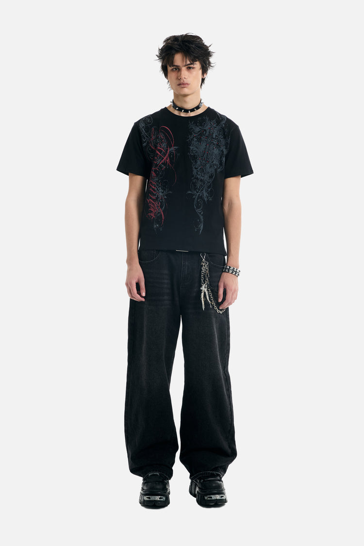 Full-length front view of the Black Scripture Eclipse Tee with baggy black jeans