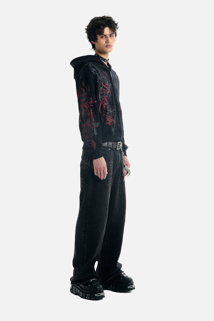Three-quarter full-length view of the Black Scripture Eclipse Zip Up Hoodie showing red sleeve prints