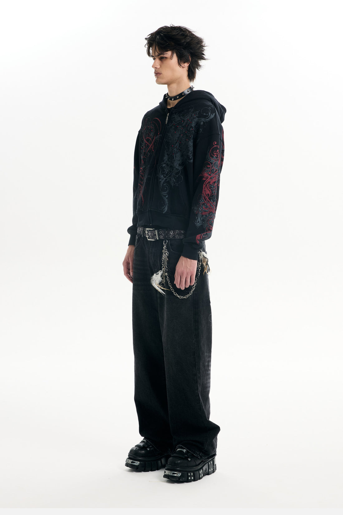 Full-length side view of the Black Scripture Eclipse Zip Up Hoodie with baggy black jeans
